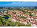 Aerial view showing the townhome's location in a community with a lake at 1940 Lobelia Dr, Lake Mary, FL 32746