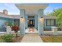 Front entrance with a covered porch, light fixtures, and a tiled walkway at 5016 Dorman Rd, Lakeland, FL 33813