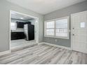 Dining area with kitchen view and wood-look floors at 143 N Woodward Ave, Deland, FL 32720