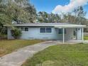 Newly painted light blue ranch home with carport at 143 N Woodward Ave, Deland, FL 32720