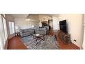 Spacious living room with hardwood floors, two sofas, and a large TV at 2749 N Poinciana Blvd # 16, Kissimmee, FL 34746