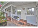 Inviting front porch with brick flooring and a bench at 3814 E Esther St, Orlando, FL 32812