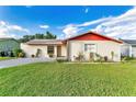 House with a red roof and well-maintained lawn at 448 Ball Ct, Kissimmee, FL 34759