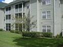 Side view of condo building showcasing screened balconies and landscaping at 6106 Westgate Dr # 102, Orlando, FL 32835