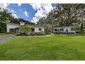 Modern home with a unique architectural design and expansive lawn at 12550 Lakeshore Dr, Clermont, FL 34711