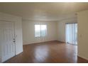 Bright living room featuring wood floors and sliding glass doors at 2260 Cascades Blvd # 107, Kissimmee, FL 34741
