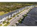 Aerial view of a townhome community with a long street and lush landscape at 8987 Cabot Cliffs Dr, Davenport, FL 33896