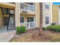 Exterior view of condo building entrance with staircase and walkway at 1037 S Hiawassee Rd # 2815, Orlando, FL 32835