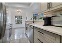 Modern kitchen with gray cabinets, quartz countertops, and stainless steel appliances at 1037 S Hiawassee Rd # 2815, Orlando, FL 32835