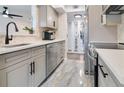Modern kitchen with gray cabinets, quartz countertops, and stainless steel appliances at 1037 S Hiawassee Rd # 2815, Orlando, FL 32835