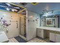 Bathroom with walk-in shower, double vanity, and decorative wall art at 1716 Sprucewood Ln, Orlando, FL 32818