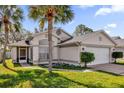 Side view of a single story house with palm trees and a screened porch at 2238 Wyndam Way, Kissimmee, FL 34743
