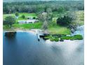 Aerial view of waterfront home with private dock and lush green surroundings at 2555 Gabriel Rd, Fort Meade, FL 33841