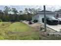 Landscaped side yard with some outdoor equipment at 513 Mallard Ct, Poinciana, FL 34759