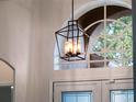 Close-up of a stylish light fixture in the entryway at 8019 Arcadian Ct, Mount Dora, FL 32757