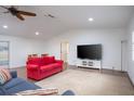 Spacious living area with hardwood floors, a large TV, and comfy couches at 1001 Hobson St, Longwood, FL 32750