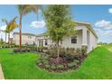 One-story home with gray siding, stone accents, and landscaped yard at 1708 Columbus Path, St Cloud, FL 34771
