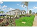 One-story home with gray siding, stone accents, and landscaped yard at 1708 Columbus Path, St Cloud, FL 34771