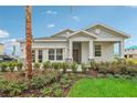 One-story home with gray siding, stone accents, and a covered porch at 1708 Columbus Path, St Cloud, FL 34771
