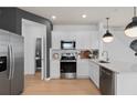 Modern kitchen featuring white cabinets, stainless steel appliances, and quartz countertops at 2555 Winsome Way, Davenport, FL 33896