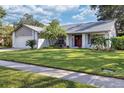 Charming ranch home with a spacious lawn and attached garage at 2778 N Horizon Pl, Oviedo, FL 32765