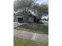 Gray house with a white garage door and landscaping at 378 Southern Charm Dr, Orlando, FL 32807
