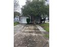 Gray house with a white garage door and landscaping at 378 Southern Charm Dr, Orlando, FL 32807