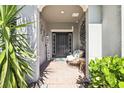 Inviting front porch with a comfortable wicker chair and welcome sign at 4113 Cypress Glades Ln, Orlando, FL 32824