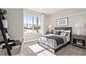 Cozy bedroom with large window and built-in desk at 5559 Flame Vine Way, St Cloud, FL 34771