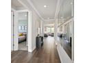 Bright hallway with hardwood floors and access to bedrooms at 5559 Flame Vine Way, St Cloud, FL 34771