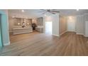 Open concept living room with kitchen and island, light wood flooring at 0 Oberly Pkwy, Orlando, FL 32833