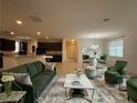 Open concept living room with green couch and modern decor at 14741 Snowy Egret St, Winter Garden, FL 34787