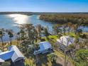 Aerial view showing home's waterfront location with a dock and lush landscape at 2239 River Ridge Rd, Deland, FL 32720