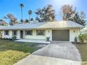 Newly renovated home with metal roof, white brick exterior, and a 2-car garage at 2239 River Ridge Rd, Deland, FL 32720