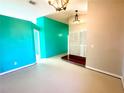 Open living space with vaulted ceilings and teal accent wall at 2585 Gramercy Dr, Deltona, FL 32738