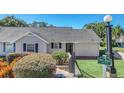 Front view of a house with a gray exterior and lush landscaping at 1084 Villa Ln # 72, Apopka, FL 32712