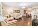 Living room with light beige furniture, hardwood floors, and a view of the dining area at 3012 Parkway Blvd # 301, Kissimmee, FL 34747