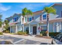 Front view of a light blue townhome with landscaping and parking at 3205 Gold Ln, Kissimmee, FL 34747