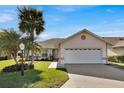 Single-story home with a garage and palm trees at 446 Sweetwater Way, Haines City, FL 33844