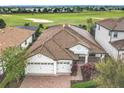 Property view showcasing a house and golf course background at 8914 Dove Valley Way, Davenport, FL 33896