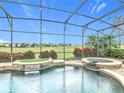 Enclosed pool and hot tub area with golf course view at 8914 Dove Valley Way, Davenport, FL 33896
