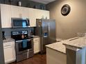 Modern kitchen with stainless steel appliances and granite countertops at 9004 Shine Dr, Kissimmee, FL 34747