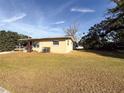 Tan single story house with large grassy yard at 1403 Amaros Ave, Orlando, FL 32811