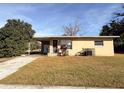Tan single story house with grassy yard and driveway at 1403 Amaros Ave, Orlando, FL 32811