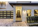 Inviting entryway with a modern door and stylish light fixtures at 1606 Hart Ln, Orlando, FL 32804