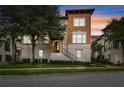 3-story townhome with Spanish-style architecture, landscaped grounds, and a 2-car garage at 1801 Lobelia Dr, Lake Mary, FL 32746
