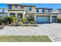 Two-story house with two-car garage and landscaped front yard at 2477 Shanti Dr, Kissimmee, FL 34746