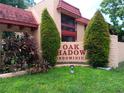 Oak Shadow Condominium entrance with lush landscaping and a welcoming atmosphere at 2860 N Powers Dr # 8, Orlando, FL 32818
