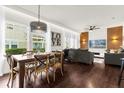 Dining area with a rustic wooden table, chairs, and a view into the living room and kitchen at 5368 Diplomat Ct # 104, Kissimmee, FL 34746