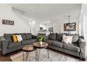 Open living room with two gray sofas, a coffee table, and views into the kitchen and dining areas at 5368 Diplomat Ct # 104, Kissimmee, FL 34746